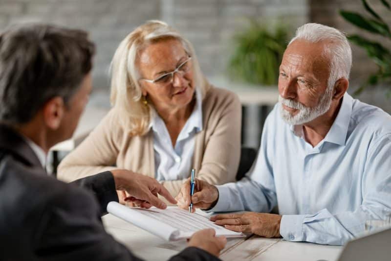 An elderly couple consults a lawyer about their case.