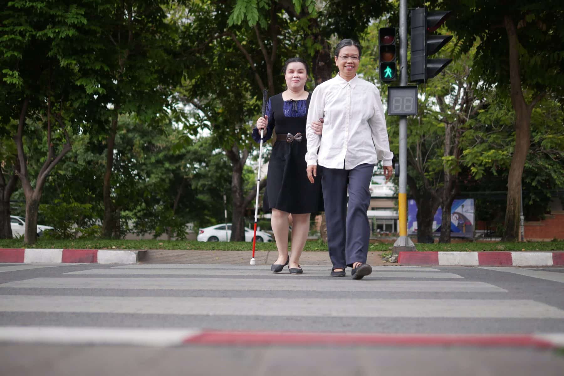A blind woman crossing the street with her mom in Los Angeles.